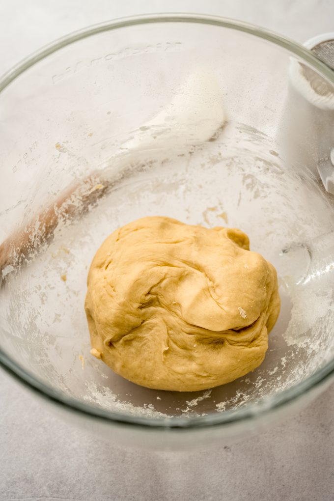 A ball of yeasted dough in a bowl before rising.