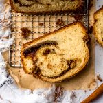 Aerial photo of a loaf of cinnamon babka on wire rack.