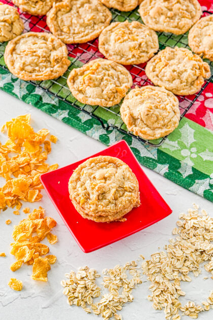 corn falke cookie on a red plate next to cooling rack with more cookies