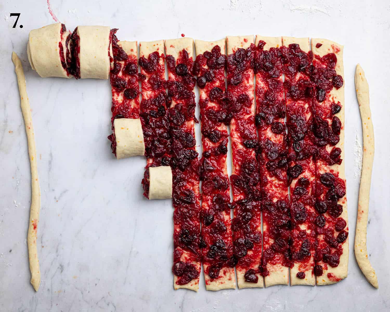 Step 7, the dough cut into strips, being rolled into spirals.