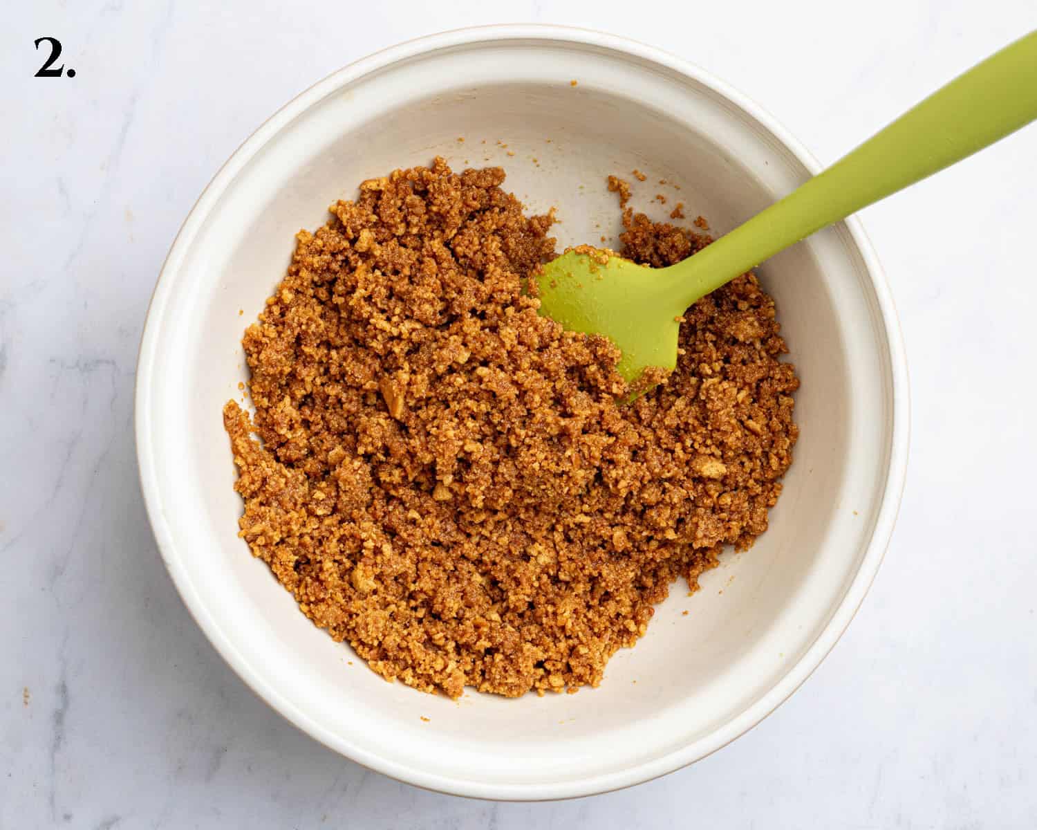 Step 2, the crushed biscuits mixed with the butter.