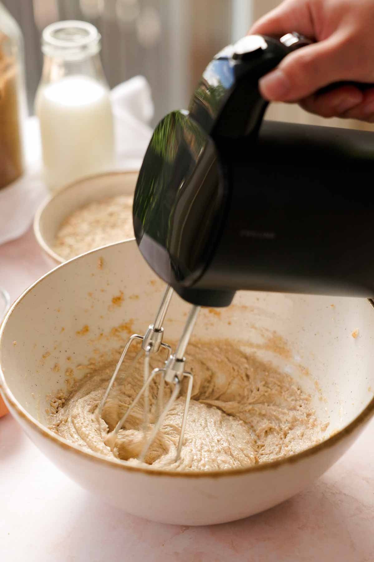creaming butter, oil, and sugar in a bowl for oatmeal ice cream sandwiches