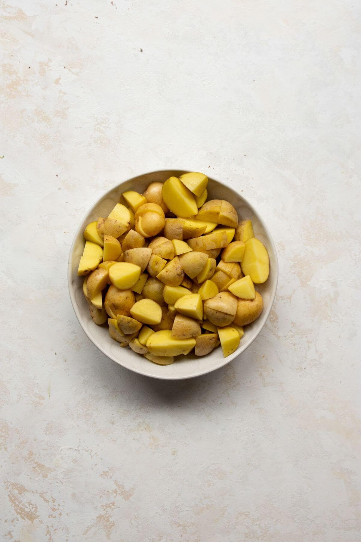 cut up baby yellow potatoes in a bowl