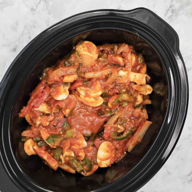 Overhead view of process shot 4 - finally, pour the mixture over the chicken, cover, and cook on low for 6-7 hours.