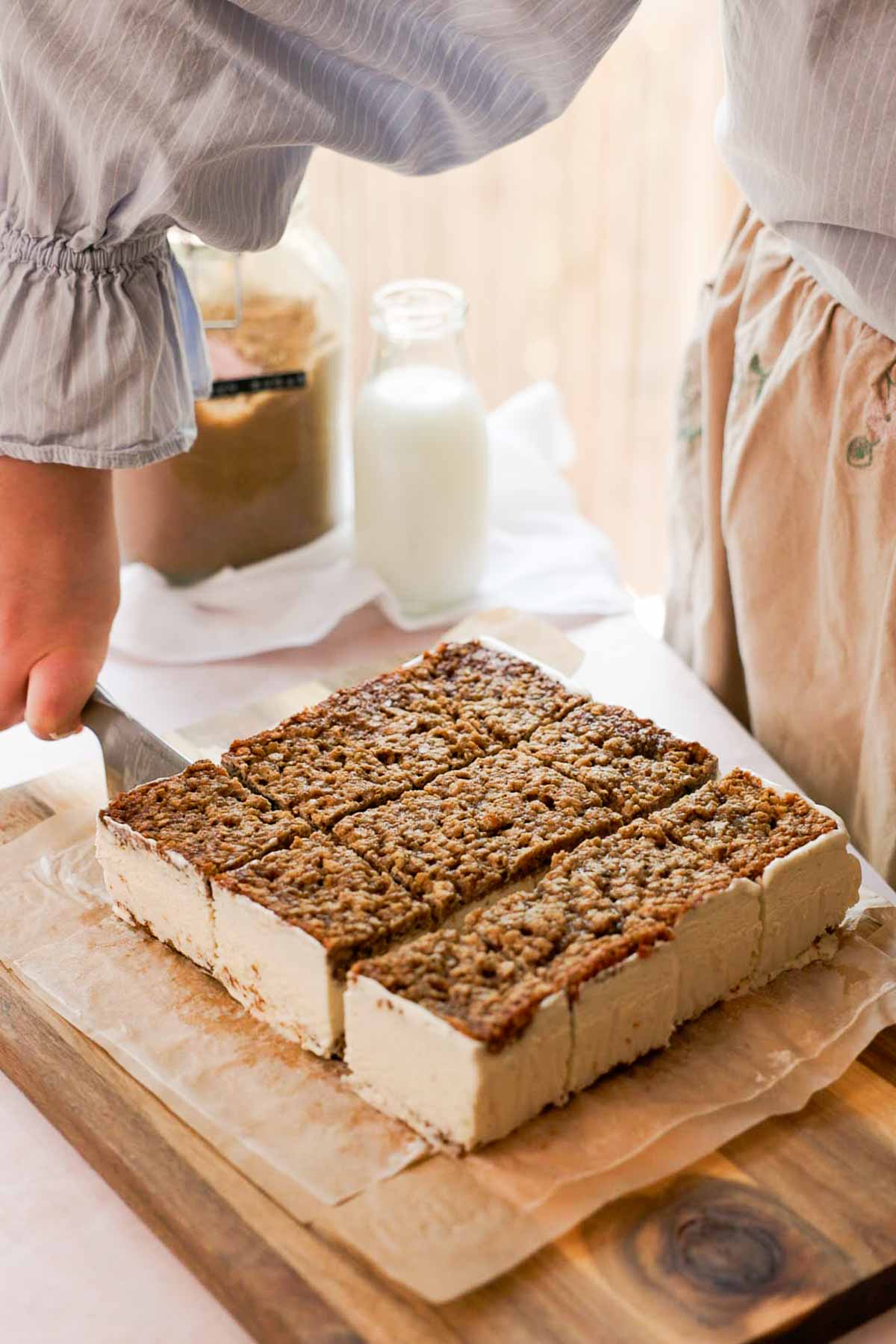 cutting oatmeal ice cream sandwich cookies into smaller rectangles with a knife