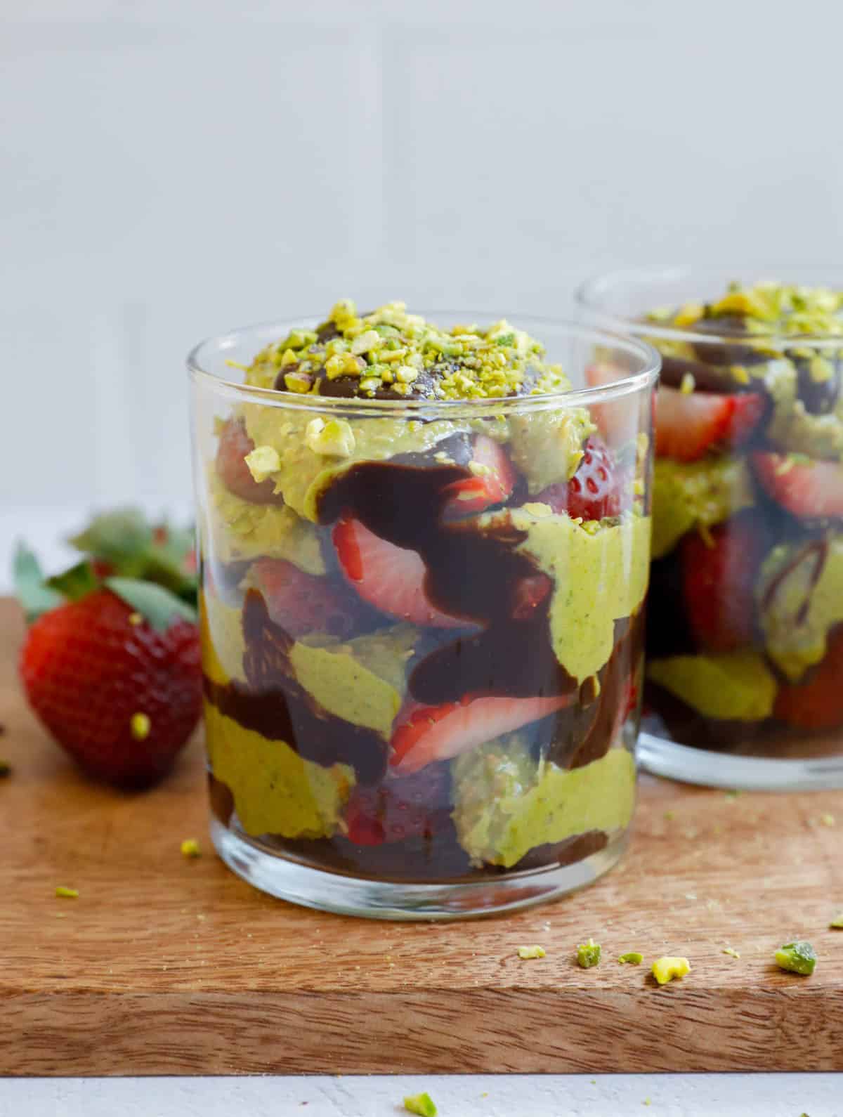 Two Dubai Strawberry Cups on a brown board.