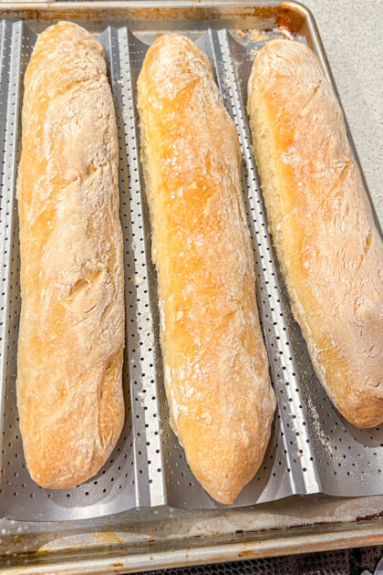 cooked baguette loaves in a baguette pan