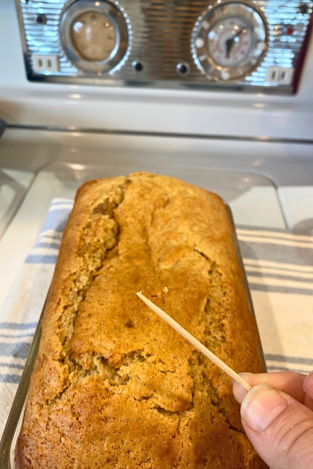 eggnog bread loaf right out of oven... testing for doneness with a toothpick