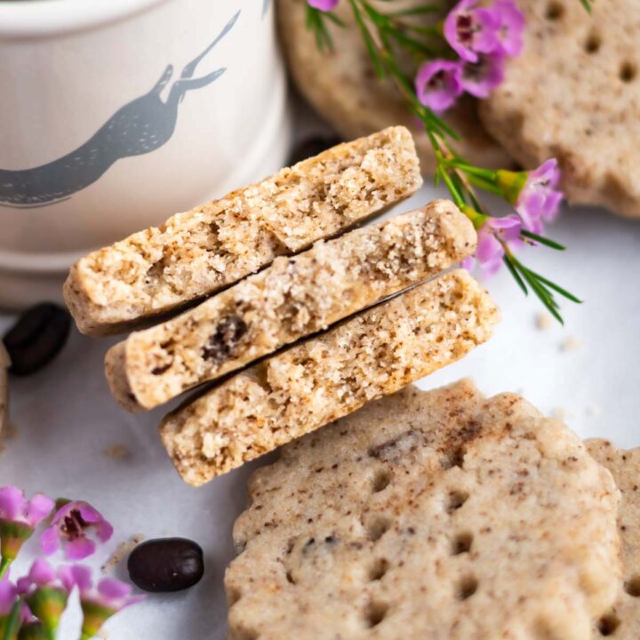 espresso shortbread cookies broken in half to show tender and slightly crumbly texture