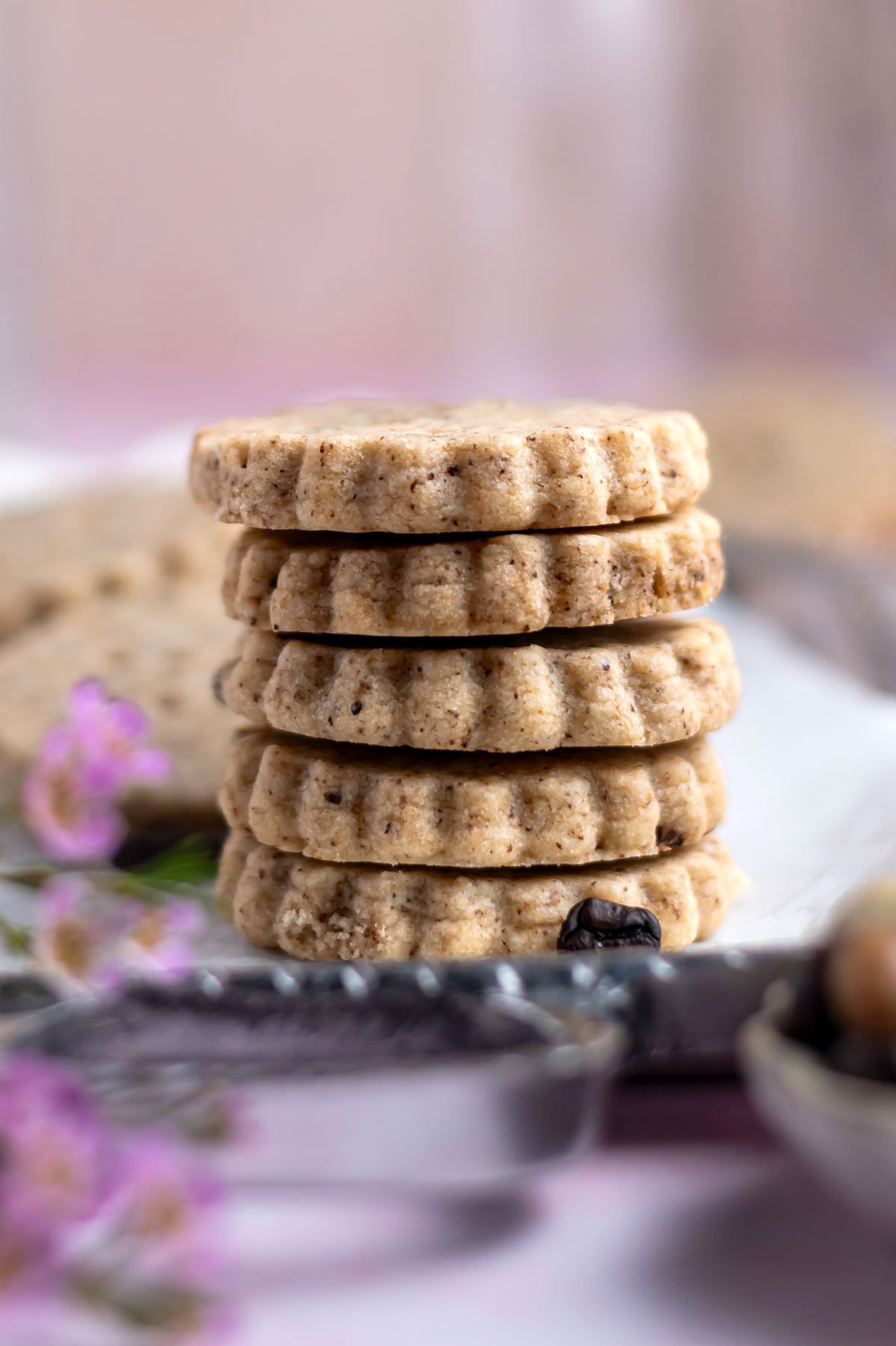 stack of cookies with flowers in the foreground