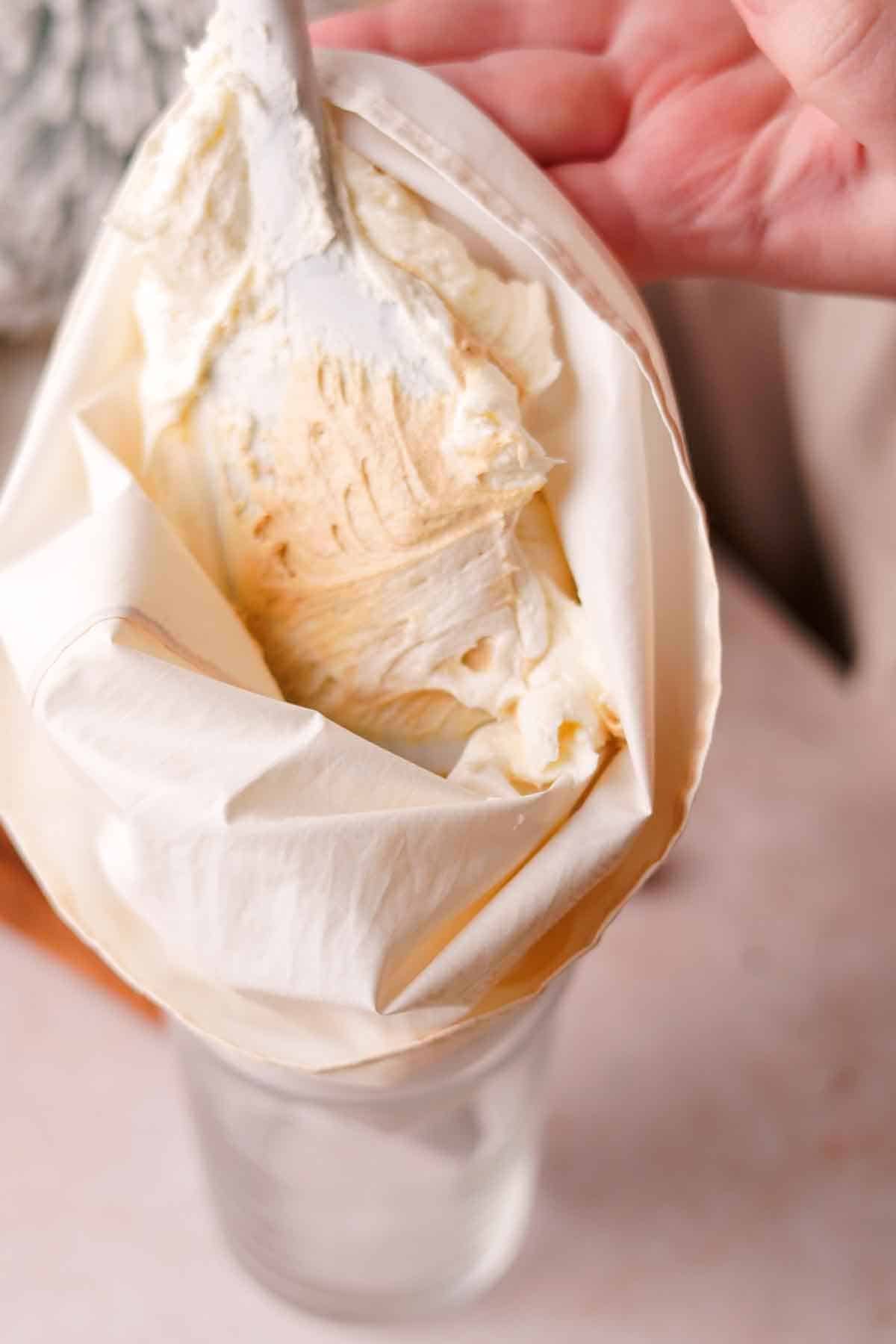 filling piping bag with frosting