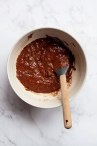 almond butter flourless brownies batter in a mizzing bowl