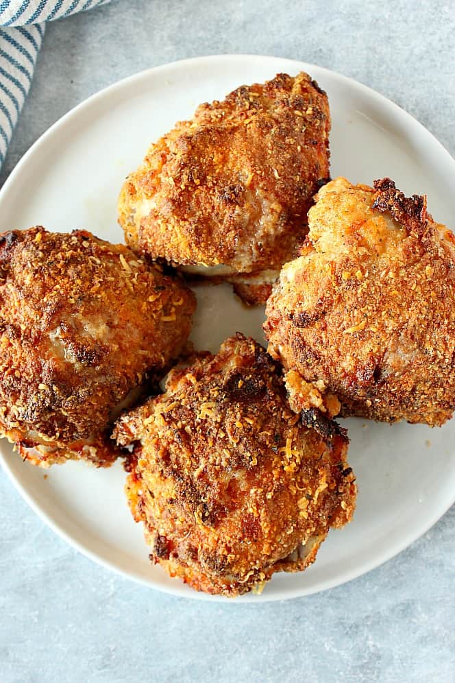This Air Fryer Fried Chicken is juicy inside and crispy on the outside. Four air fried chicken thighs on white plate.