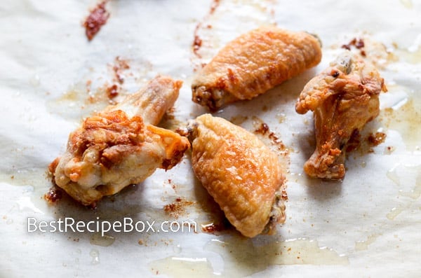 Cooked chicken wings on a baking sheet