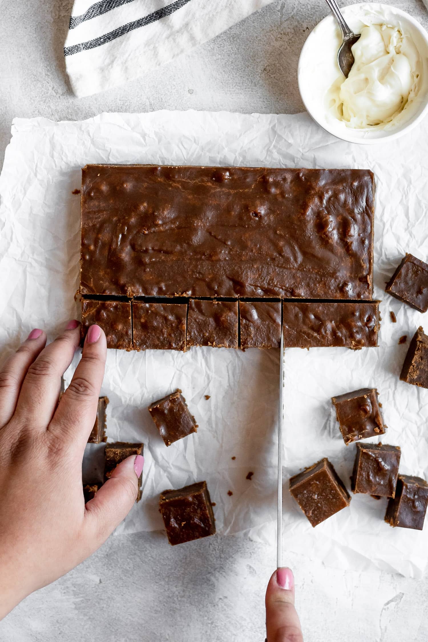 hands cutting candy into small pieces