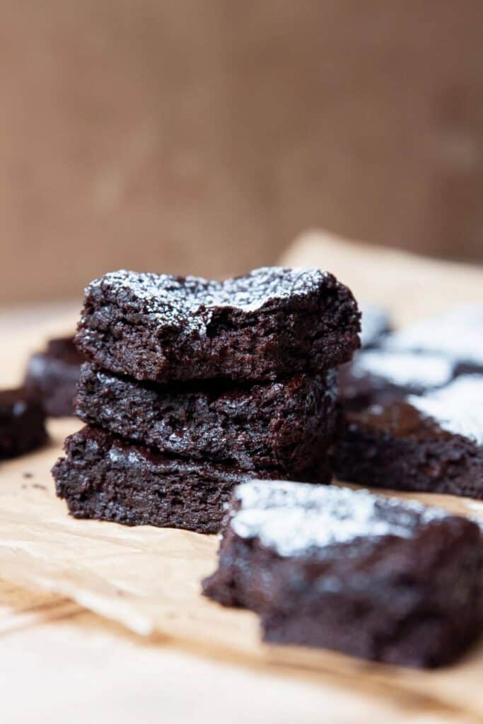 stack of three healthy avocado banana brownies to show extra gooey and fugy centers