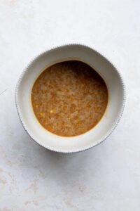 mashed banana, maple syrup, eggs, coconut oil, and vanilla whisked together in a bowl