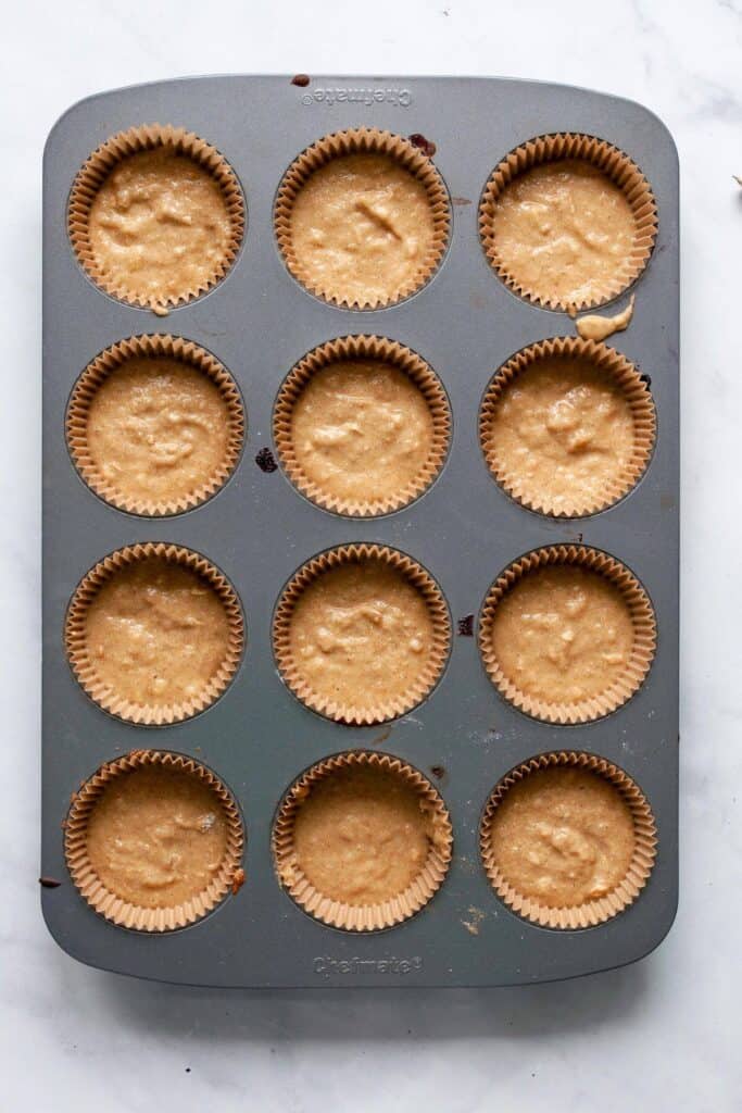 healthy banana muffin batter in 12 muffin liners
