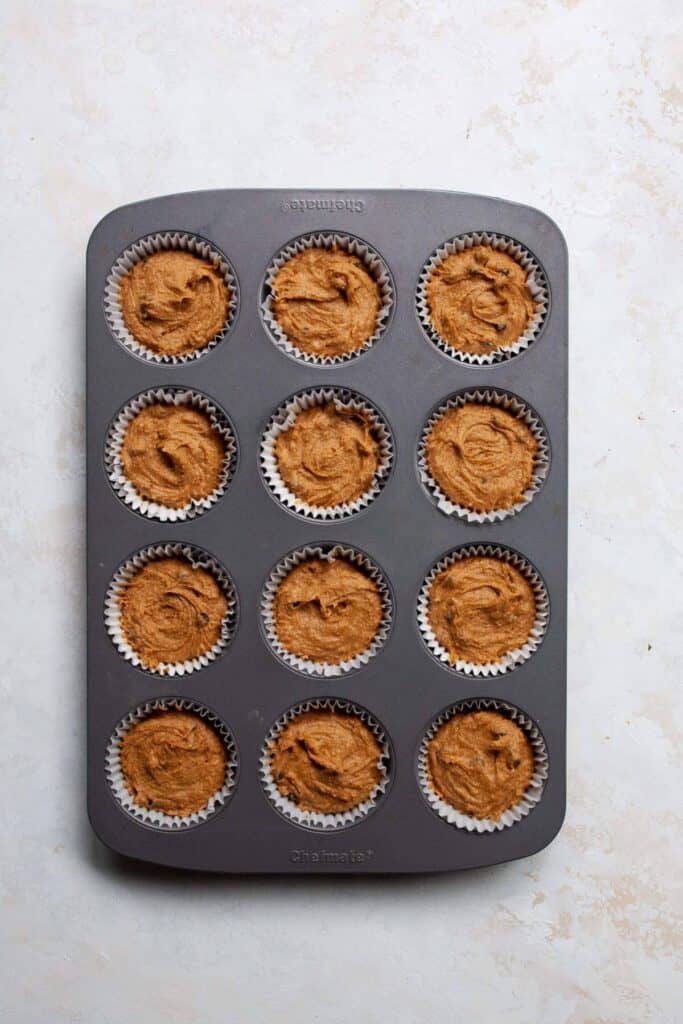 healthy pumpkin muffins batter in cupcake tin with liners before baking