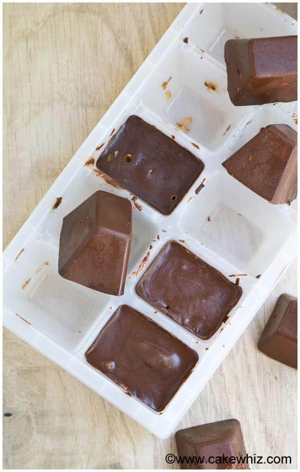Ice Cube Tray Chocolate Candy on Wood Background