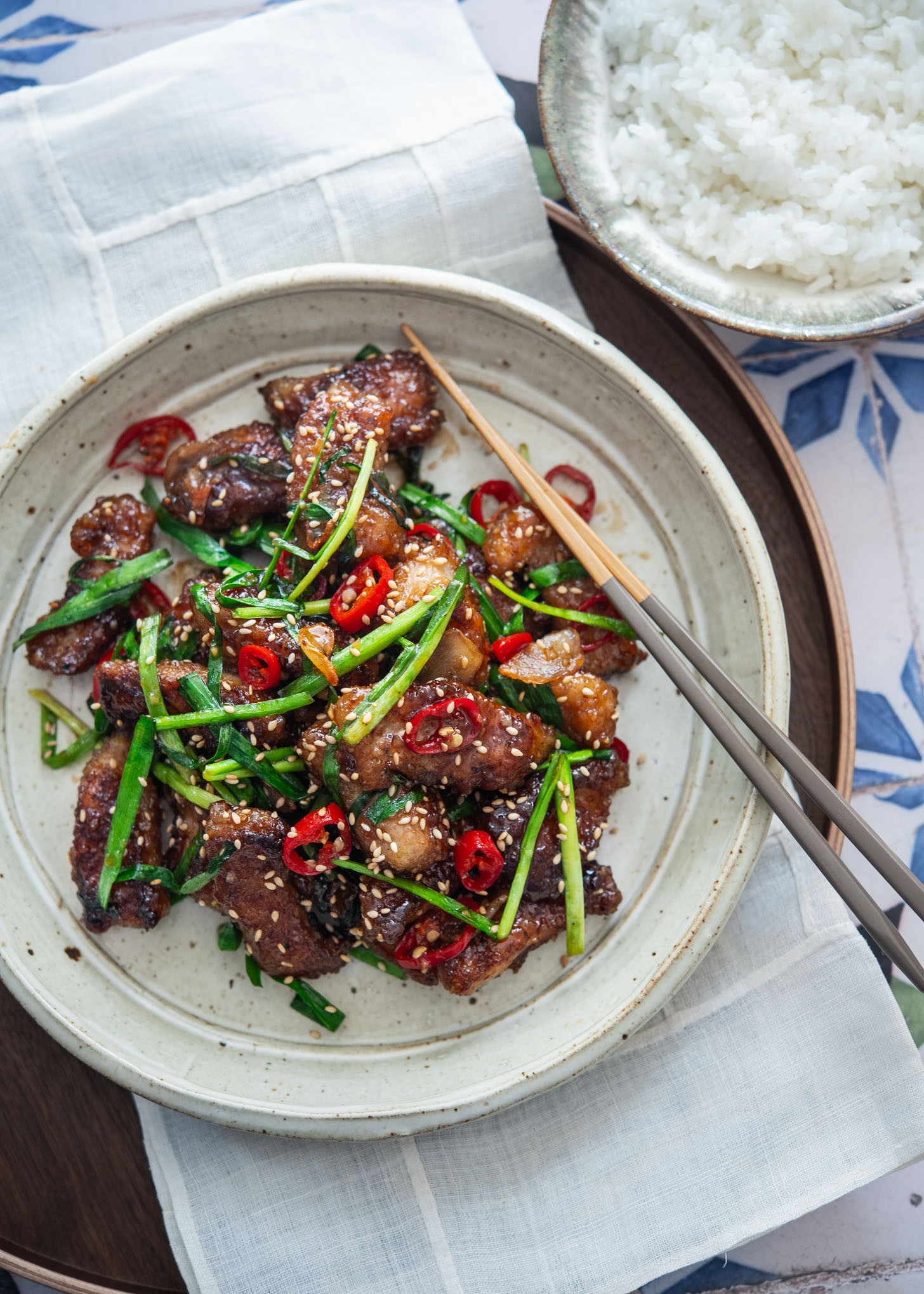 Plated Korean-style honey garlic pork served alongside steamed white rice