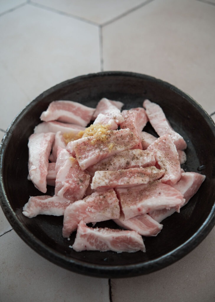 Diced pork mixed with seasoning in a bowl