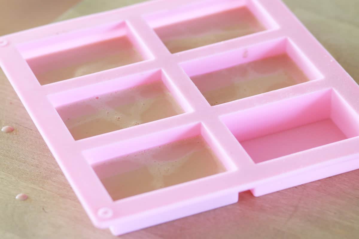a silicone soap mold with melted soap mixture poured inside