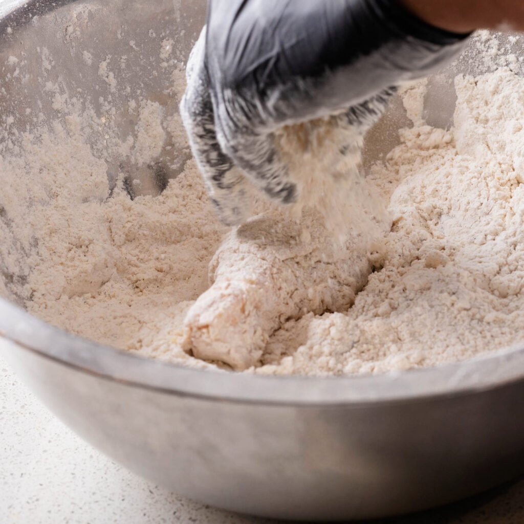 dredging chicken in seasoned flour