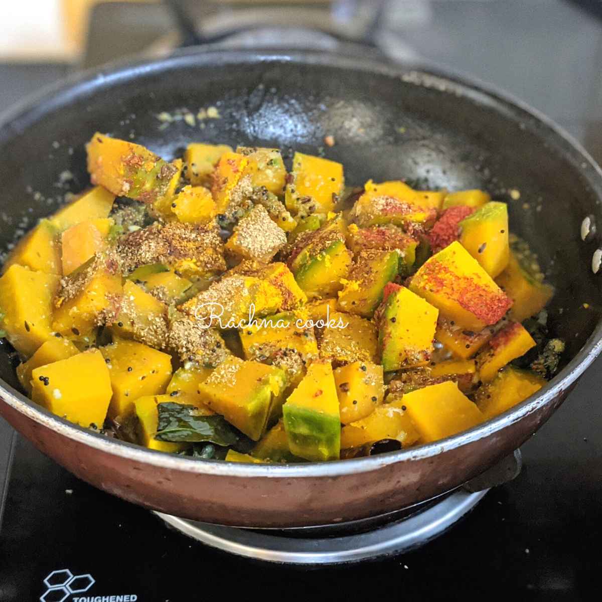 Pumpkin pieces with spices in a wok