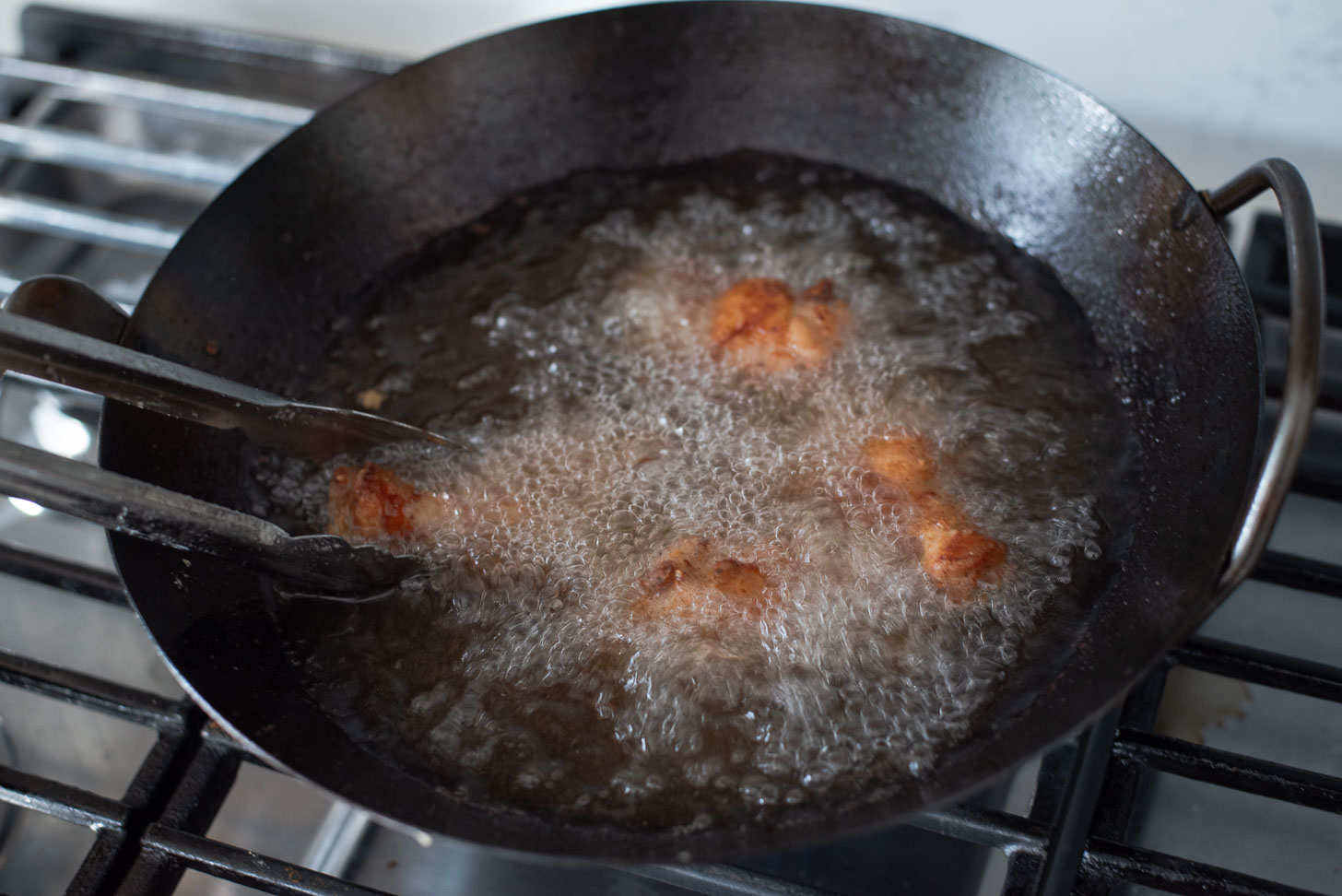 Second deep frying of chicken wings.