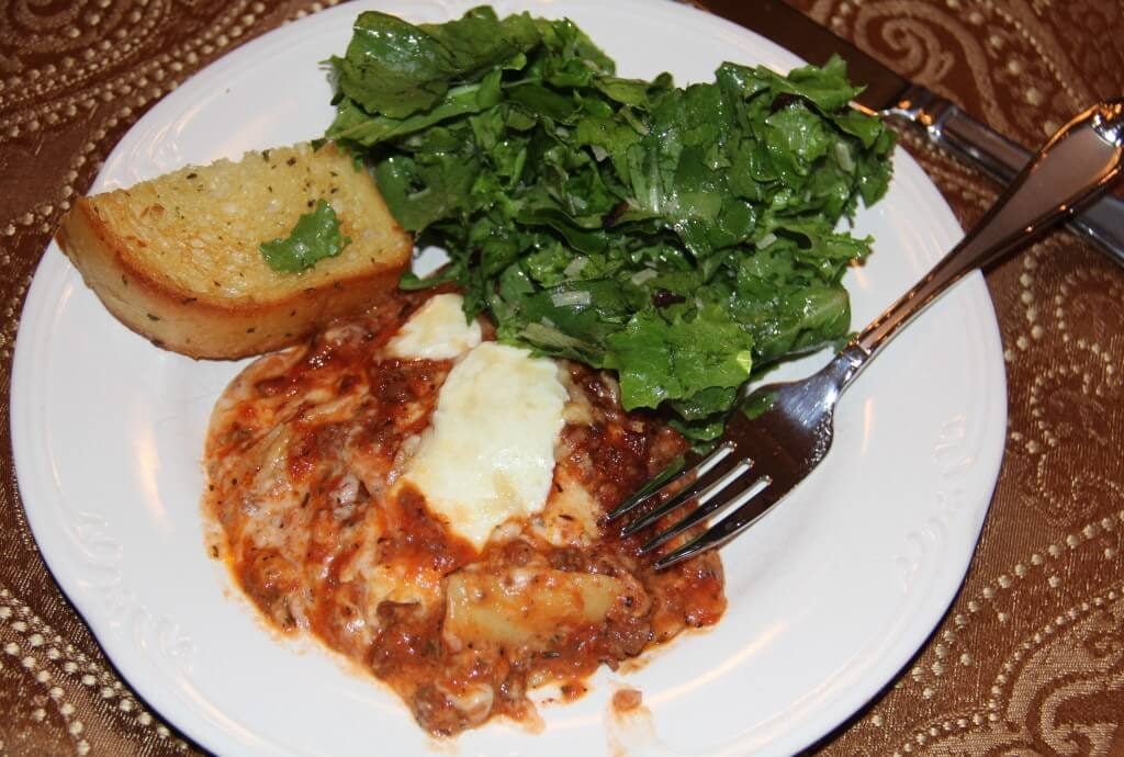 A plate of food with a fork, with Tomato and Cheese
