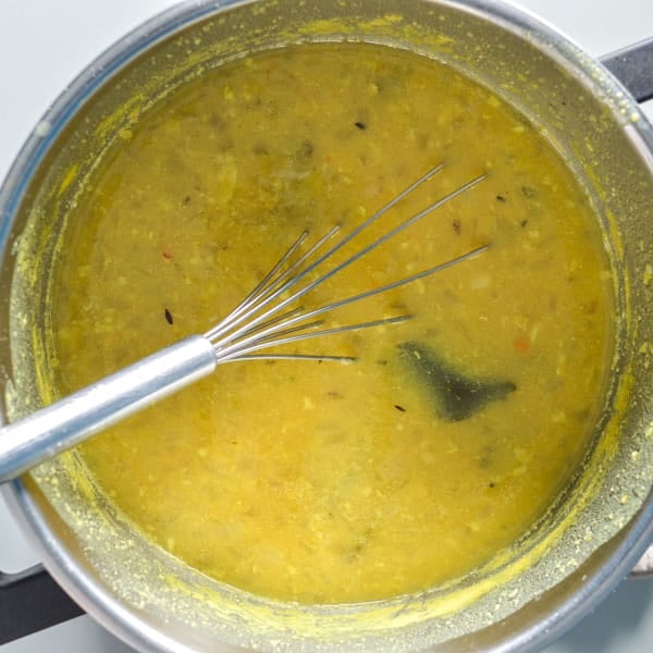 A pot of cooked yellow lentils