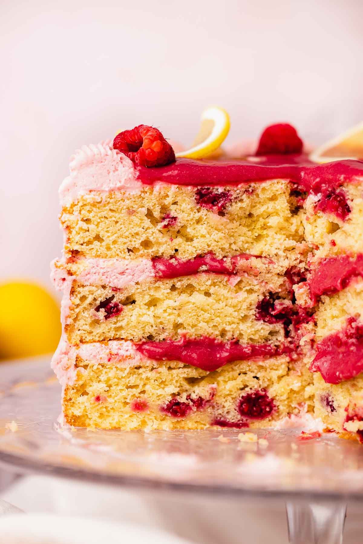 cross section of lemon raspberry layer cake with gooey raspberry curd filling 