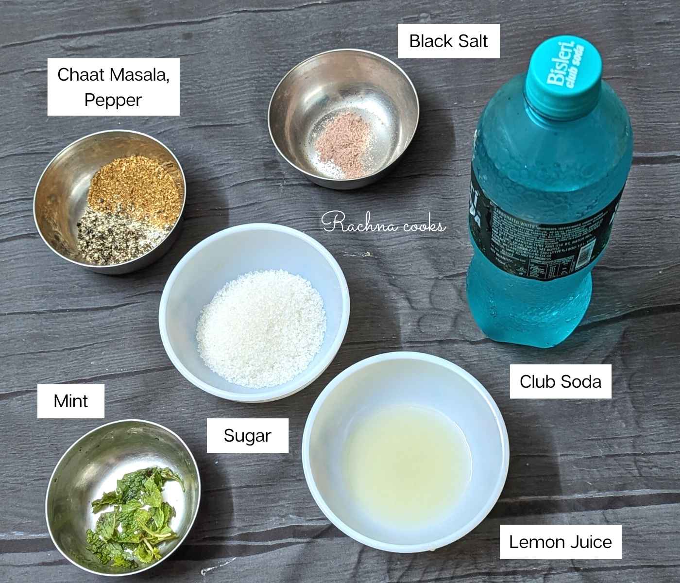 Ingredients for making masala soda: sugar, lemon juice, black salt, pepper, chaat masala, mint leaves and club soda.