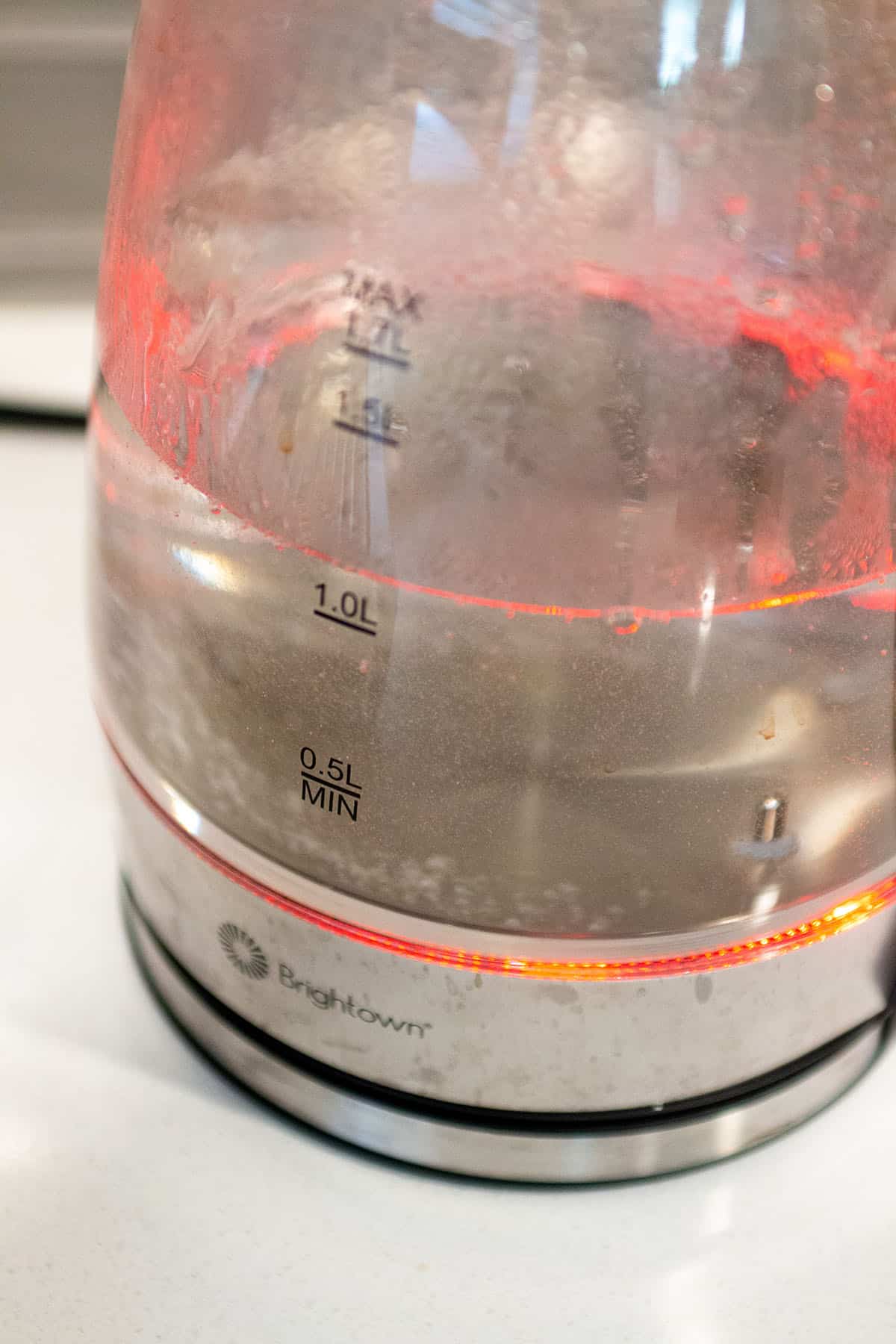 An electric kettle bringing water to a boil.