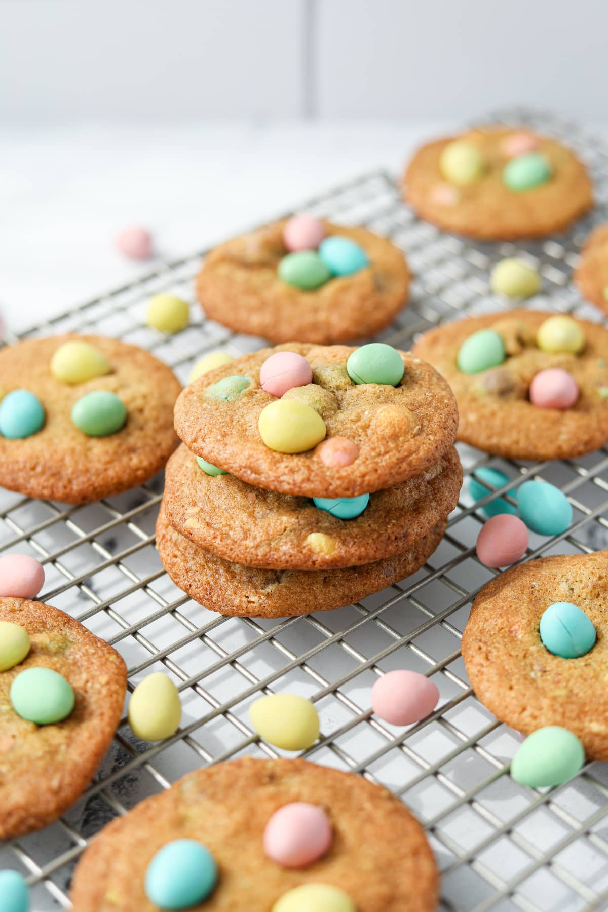 A stack of cookies on a wire rack.