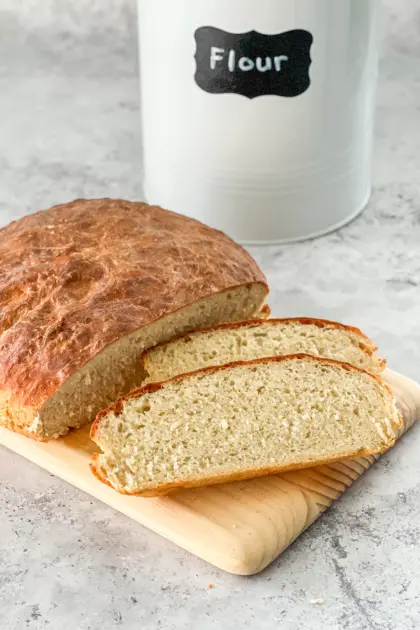 A loaf of No Knead Rustic Breadwith a few slices