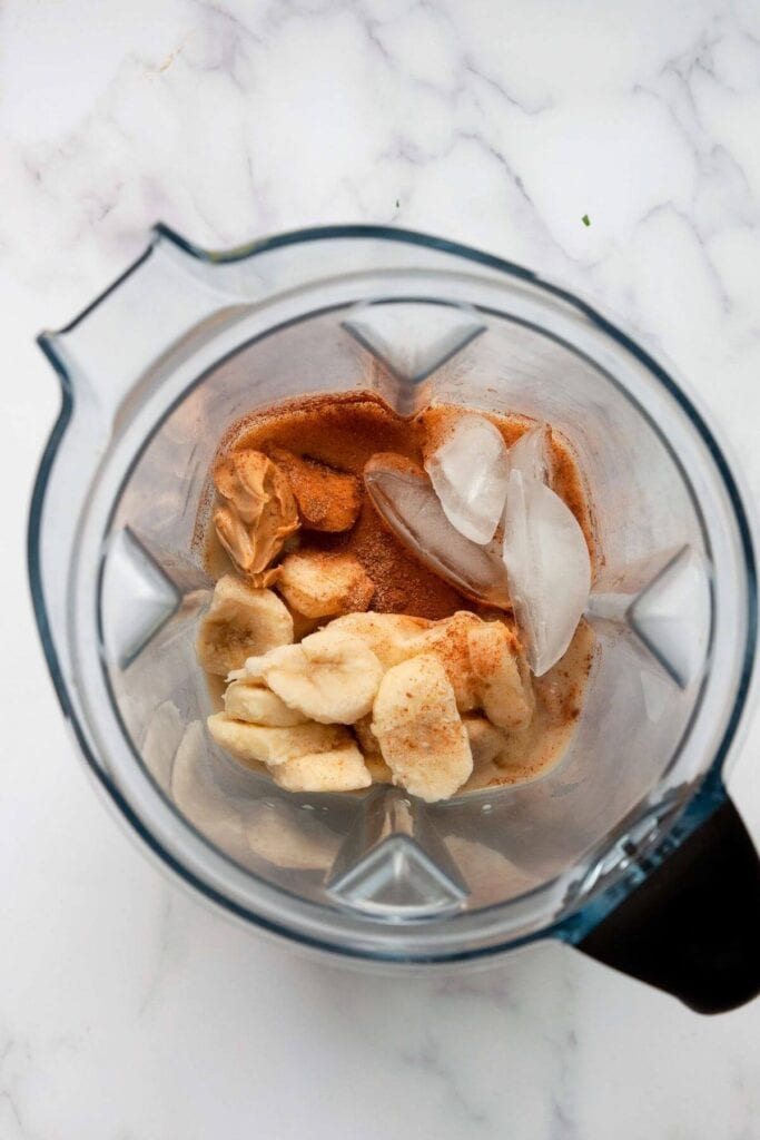 ingredients in oat milk smoothie in a blender