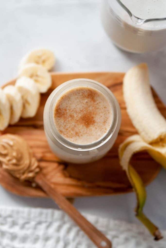 oat milk smoothie in a glass with cinnamon on top