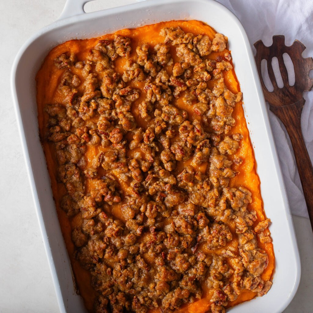 baked Old fashioned sweet potato casserole with streusel topping in a white casserole dish