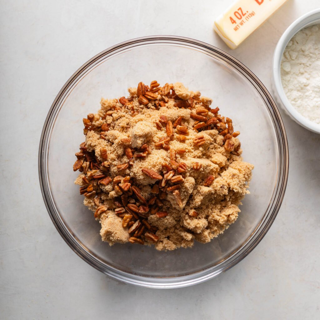 brown sugar, pecan pieces, flour, and melted butter in a glass mixing bowl