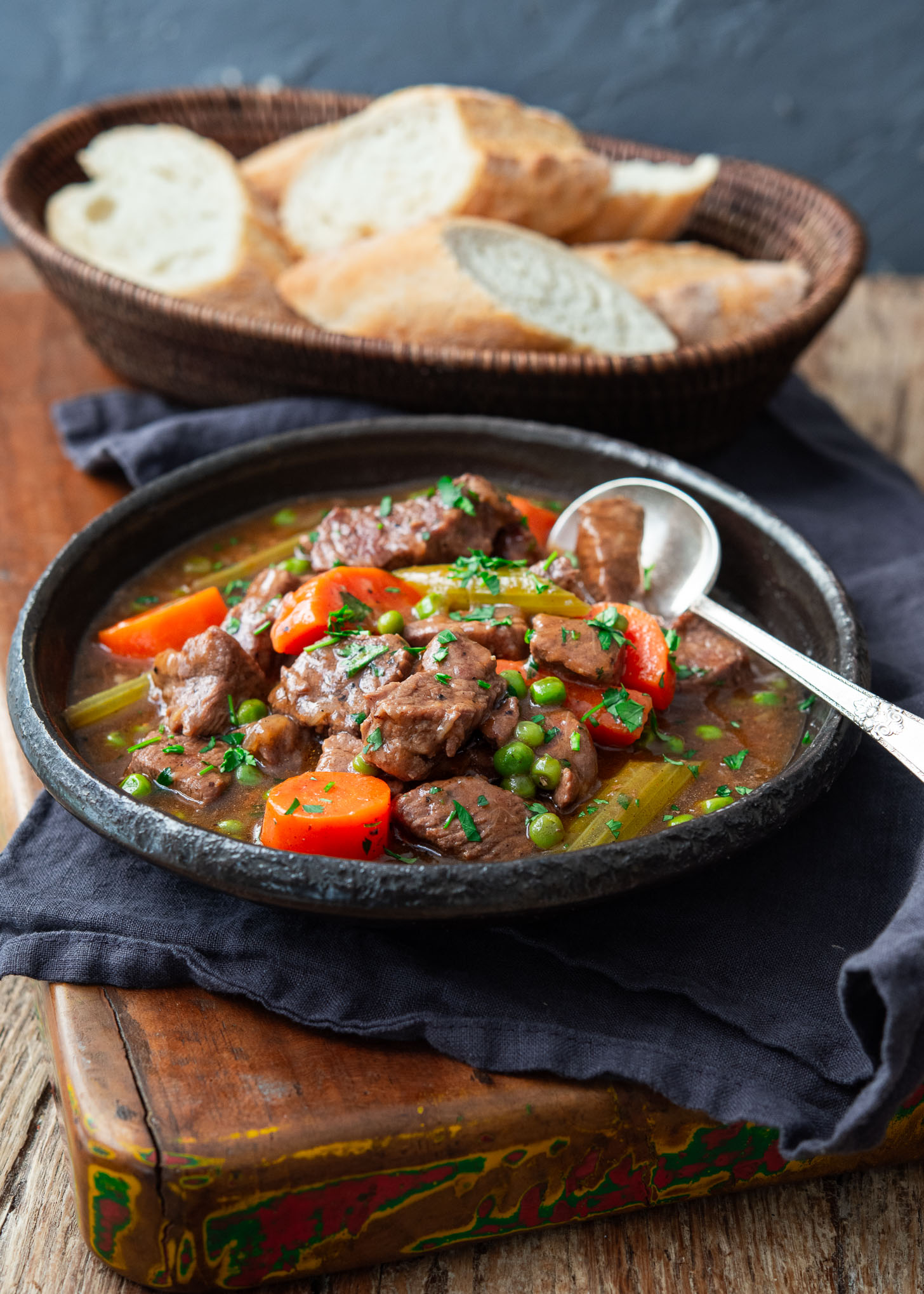 Beef stew in a bowl with a spoon.
