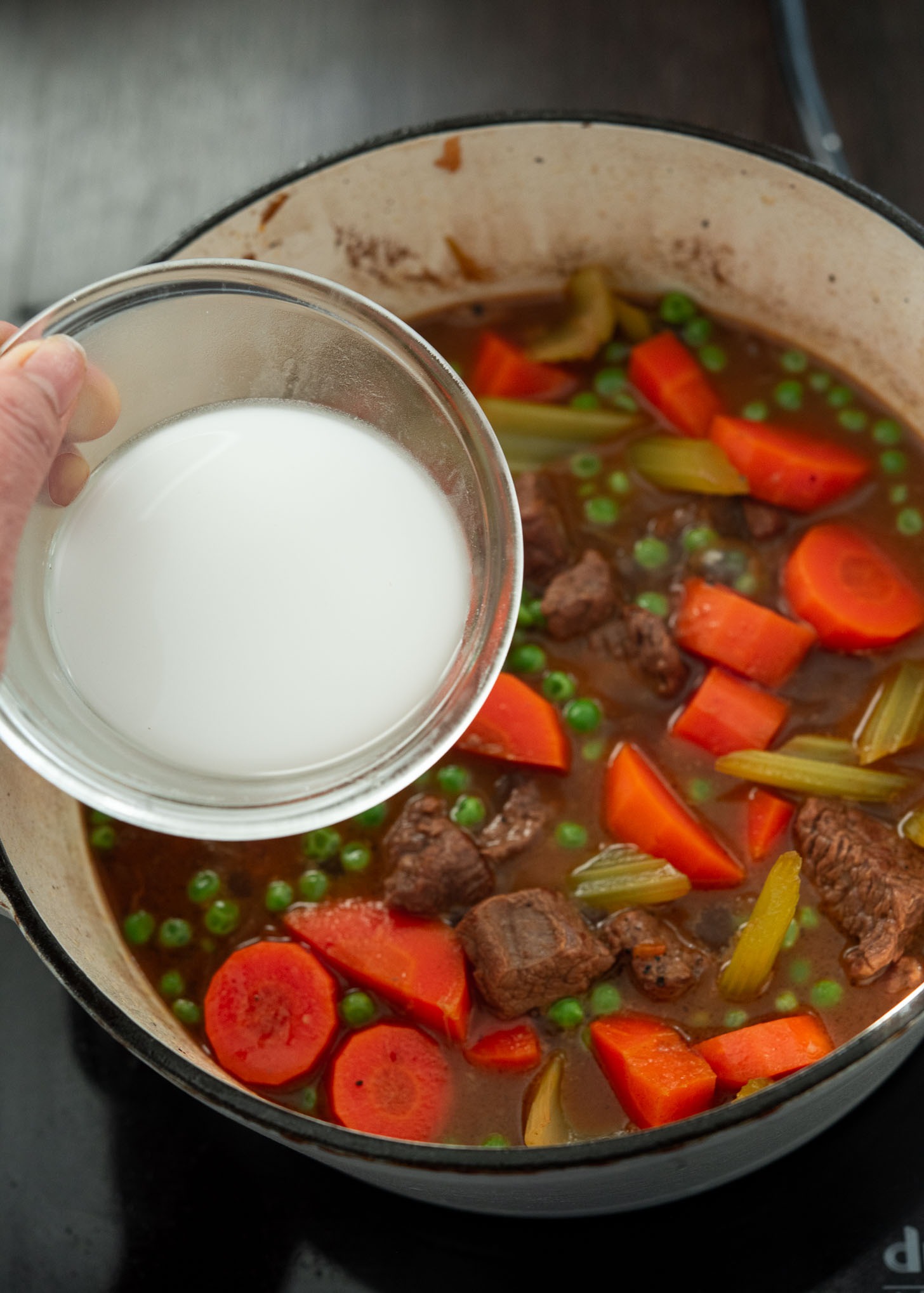Cornstarch slurry added to beef stew toward the end.