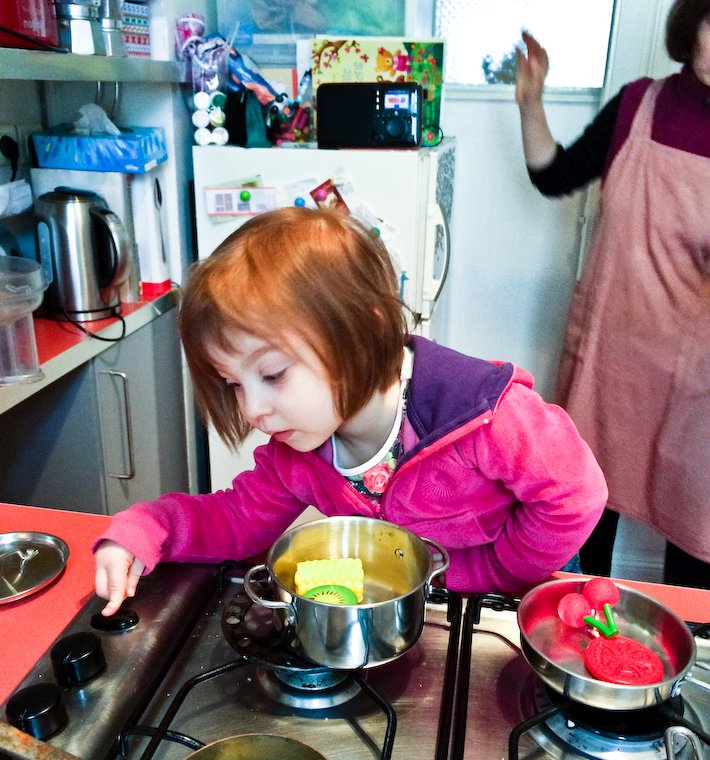 Olivia manning the gas stove (!)