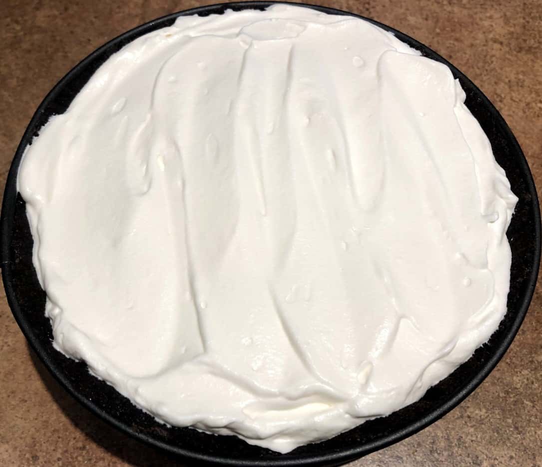 oreo ice cream pie with whipped cream on top.