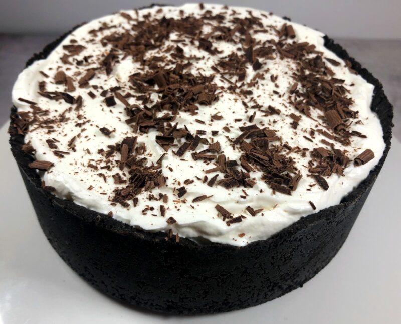 oreo crust mint ice cream pie on a pie plate with chocolate shavings on top