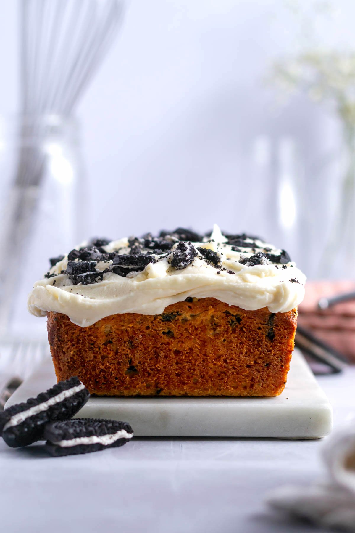 oreo pound cake with vanilla cream icing on a serving plate