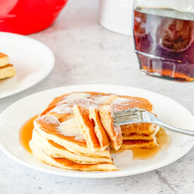 bite of stack of overnight buttermilk pancakes on fork