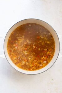tortellini soup base in a pot before adding kale, parmesan, and tortellini