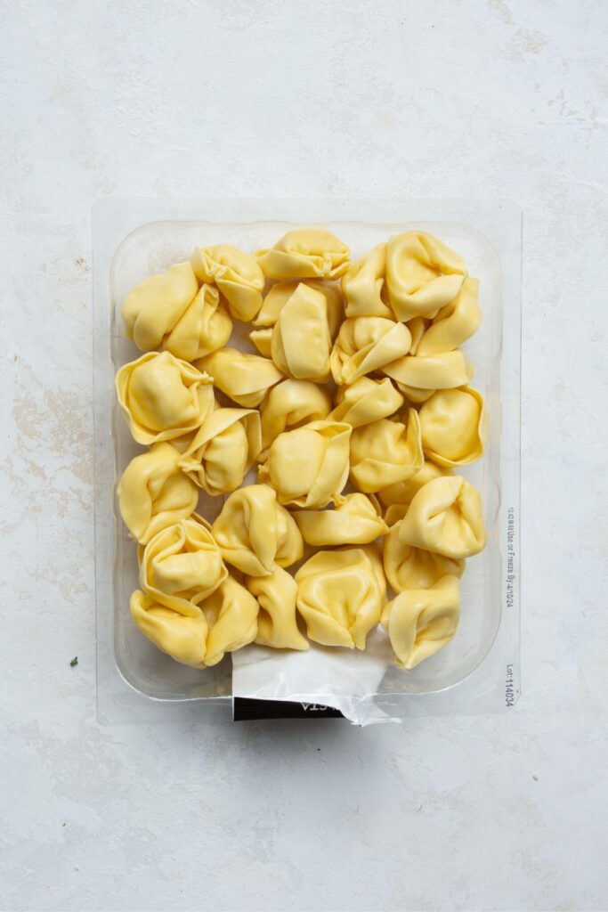 fresh cheese tortellini in it's box before cooking to show the correct type of tortellini to use for this soup